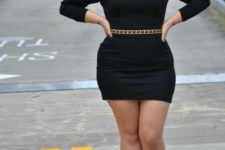 05 a black sheath mini dress with leather shoulders, a statement belt and black strappy heels