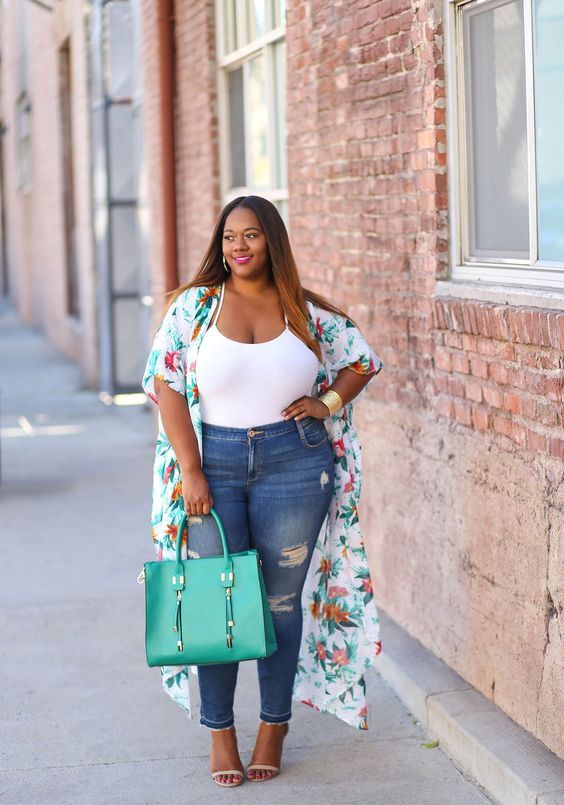 A white spaghetti strap top, blue ropped skinnies, a bold floral kimono and a bold green bag