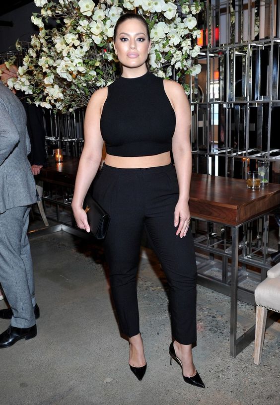 a gorgeous look with black pants, a halter neckline crop top, black heels and a clutch