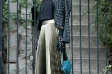 06 a metallic pleated midi skirt, a black top top, a leather jacket and a small dark green bag