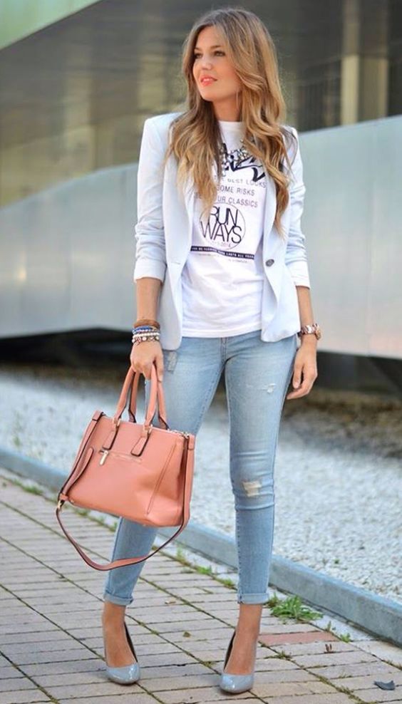 a powder blue jacket, a printed tee, blue ripped skinnies, powder blue shoes and a coral bag