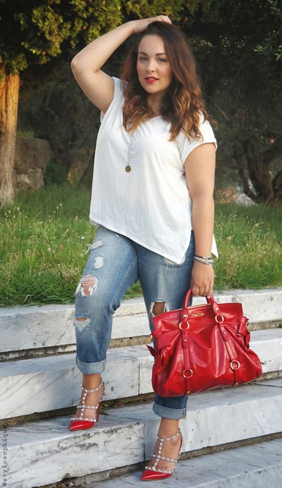 a white tee, ripped blue boyfriend jeans, red spiked heels and a red bag