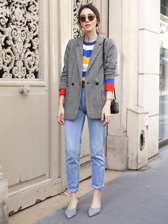blue cuffed jeans, a colorful printed tee, a grey plaid blazer and printed shoes