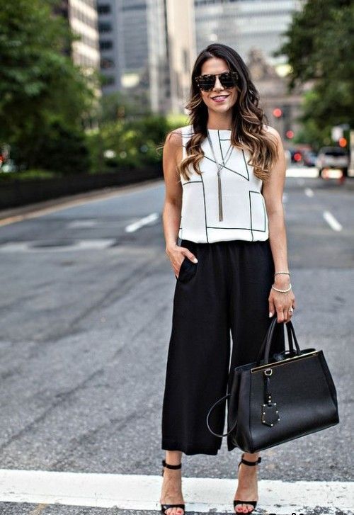 black culottes, a geometric black and white top, a black bag and black shoes