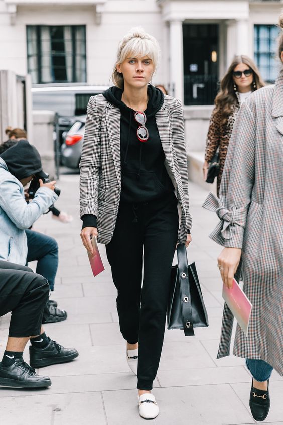 black pants and a hoodie, creamy flats and a checked grey blazer over the outfit
