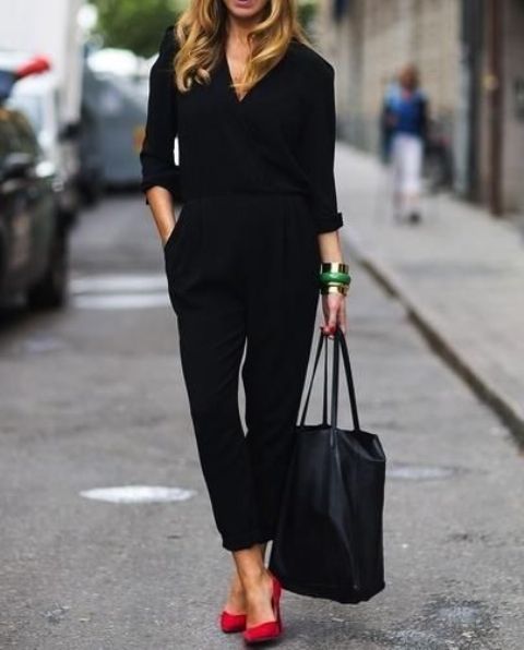 a black casual jumpsuit with long sleeves, red shoes and a comfy bag is a stylish idea for work