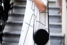 a black round crossbody bag adds interest to the monochrome outfit