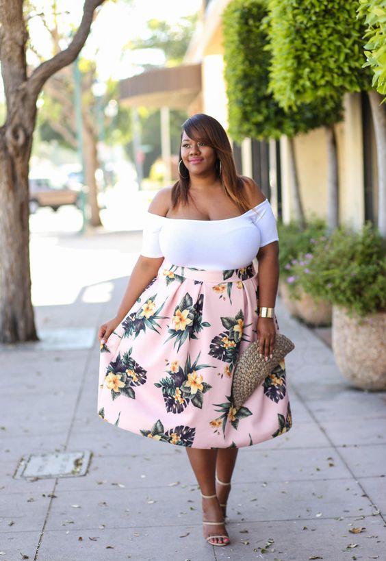 a white off the shoulder top, a pink full floral skirt, strappy heels and a wicker clutch