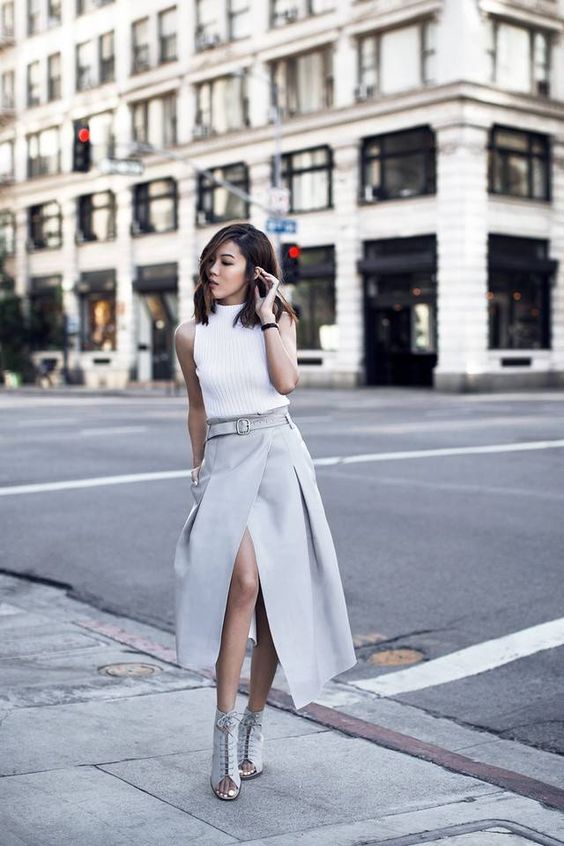 a white turtleneck without sleeves, a dove grey midi wrap skirt and matching lacing up mulles