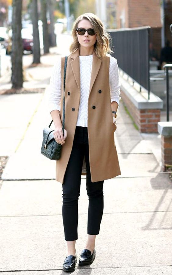black cropped skinnies, a white long sleeve, a camel long vest and black flats