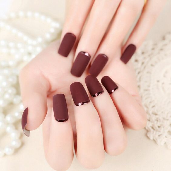 matte burgundy nails with dark copper crescent moon accents