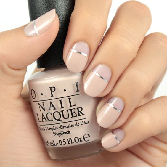 nude plus silver stripes negative space manicure for a bold modern look