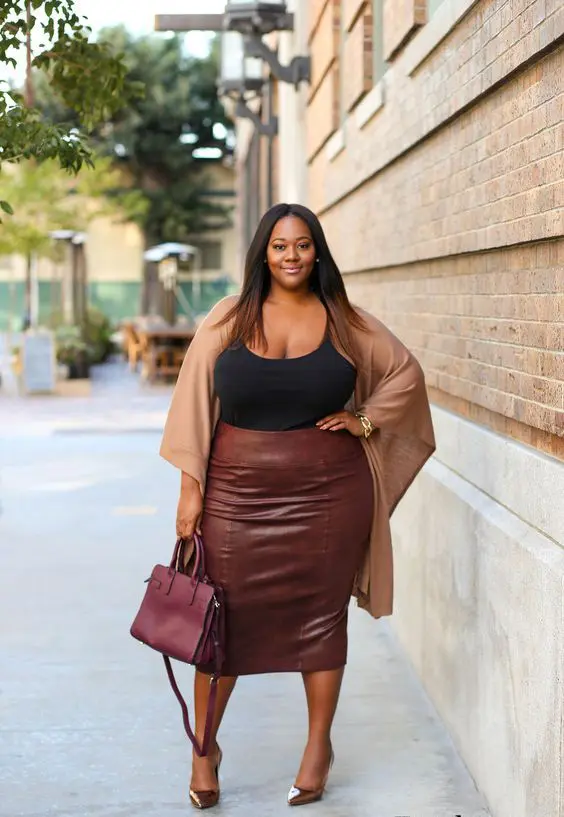 a black top, a brown leather midi pencil skirt, a tan coverup, metallic shoes and a plum bag for a wow effect
