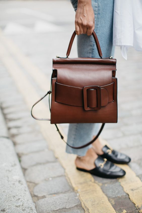 a gorgeous warm brown leather bag with an oversized buckle and strap plus handles
