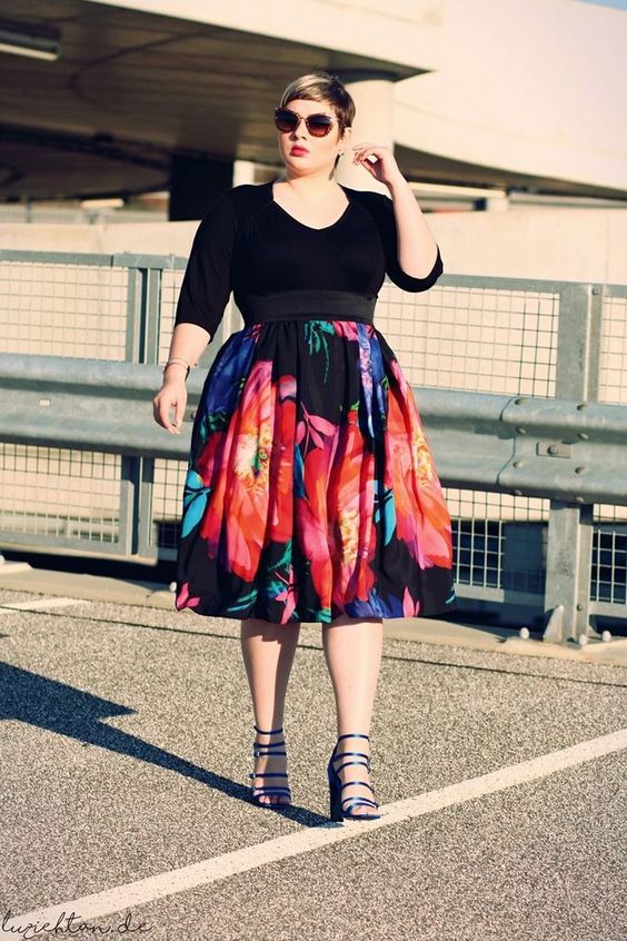 a black sleeve top, a bold floral A-line skirt, black strappy heels for a sexy look