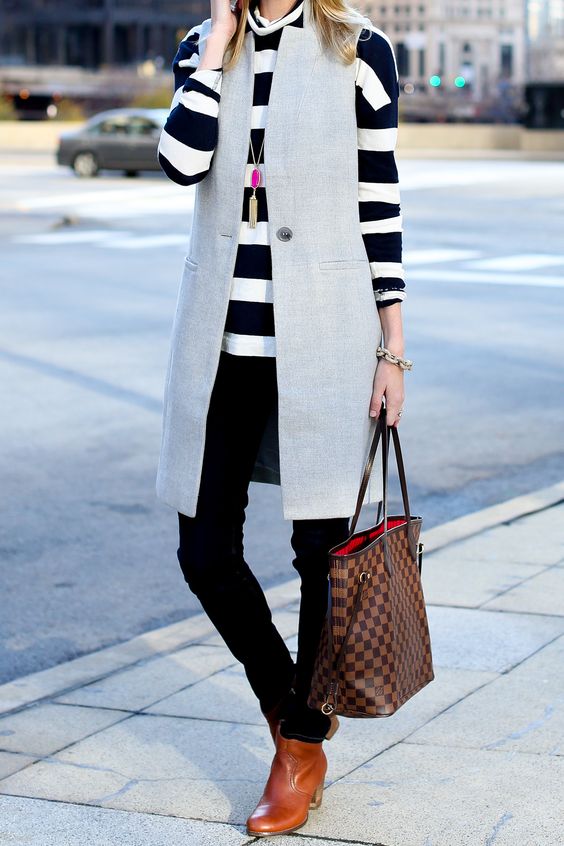 a striped long sleeve, black skinnies, amber boots, a dove grey long vest for a casual look