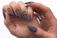 12 graphite grey matte nails with silver and black beaded stripes for an accent