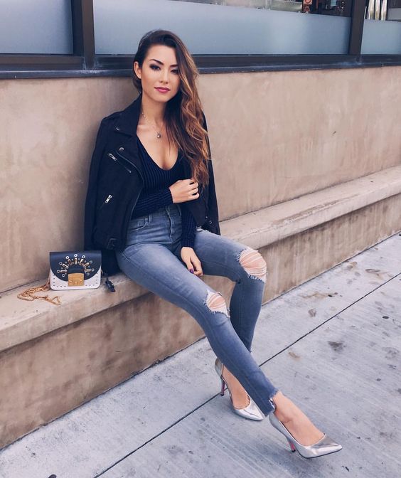 grey ripped skinnies, a black top, a black suede jacket, metallic shoes