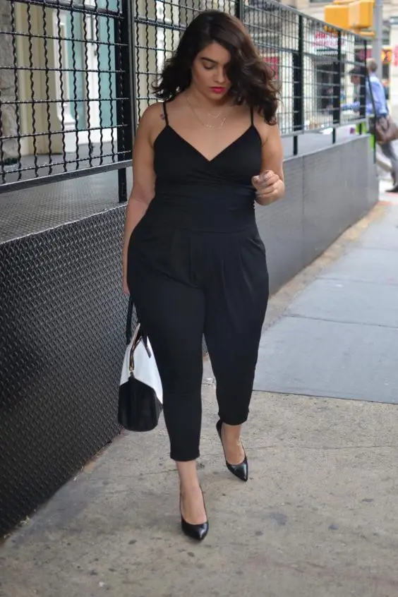a black jumpsuit with spaghetti straps, black heels and a black and white bag for a monochrome look