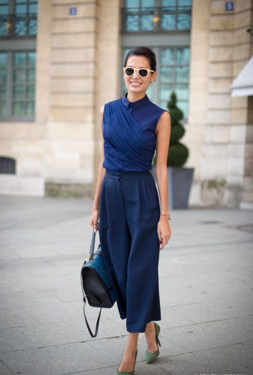 navy culottes, a navy wrap sleeveless top, green shoes and a blue bag for a chic look
