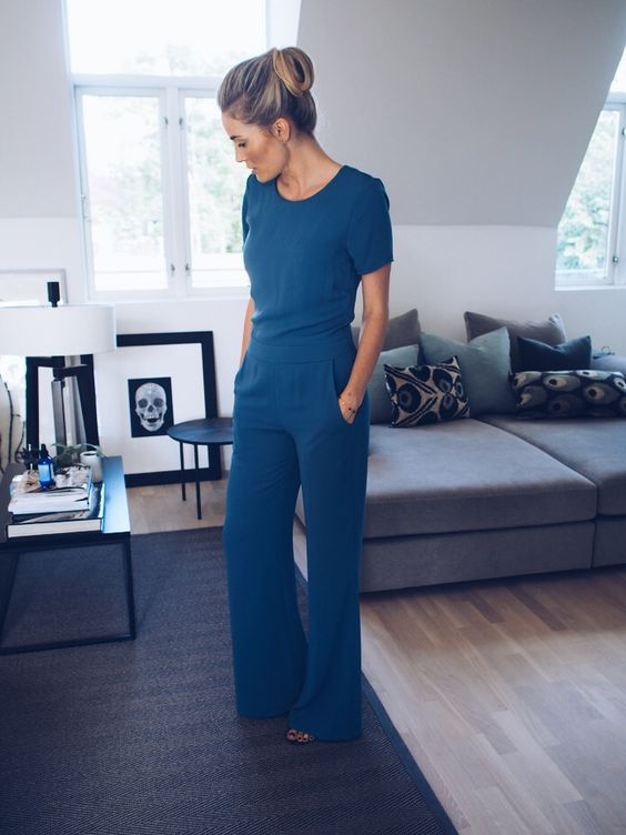 a modest teal jumpsuit with short sleeves and pockets is a perfect piece for work