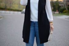 14 blue skinnies, a white blouse, a long black vest and nude shoes for a chic look