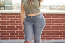 16 grey ripped jeans, an army green crop top, black boots, a hat for a comfy and sexy look