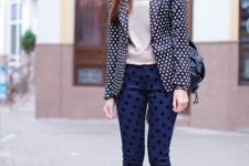 With beige shirt, navy blue polka dot pants, black bag and white shoes