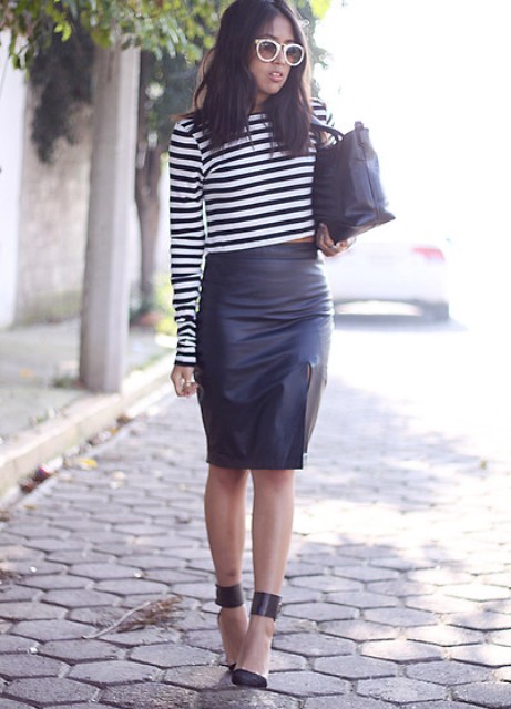 With black leather skirt, high heels and black bag