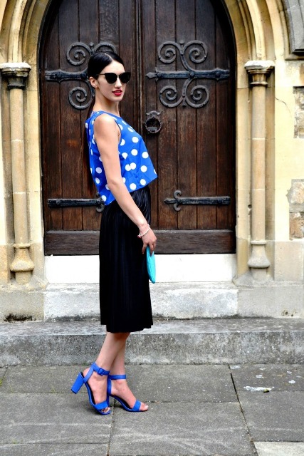With black midi skirt, blue sandals and clutch