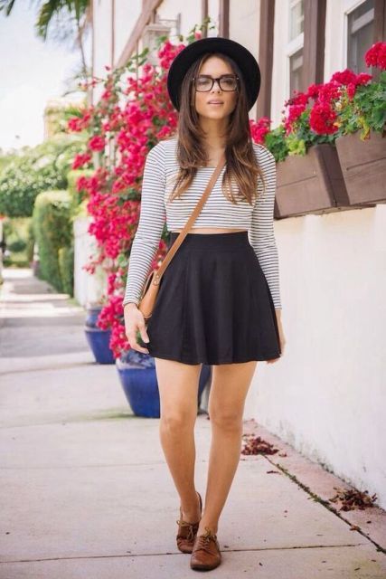 With black skater skirt, wide brim hat, brown flats and crossbody bag