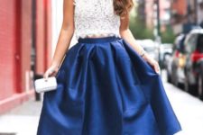 With blue midi skirt, beige high heels and white clutch
