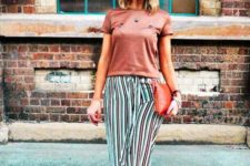 With bronze t-shirt, red clutch and brown sandals
