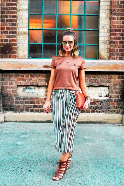 With bronze t-shirt, red clutch and brown sandals