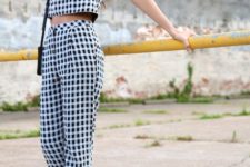 With checked trousers, black sandals and black small bag