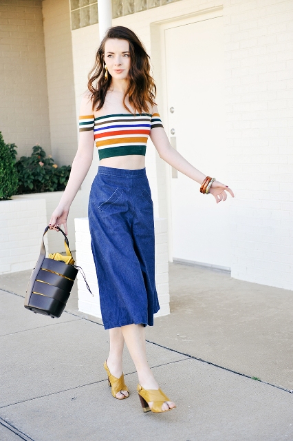 With denim culottes, yellow sandals and black leather bag
