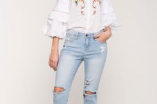 With distressed jeans and platform sandals