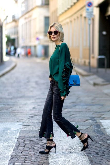 With emerald shirt, flare pants, heels and blue bag