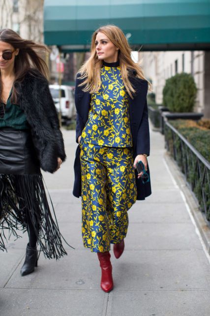 With floral blouse, navy blue coat and red boots