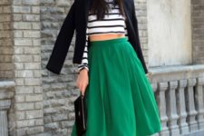 With green skirt, black pumps, black blazer and clutch