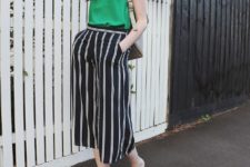 With green top, beige bag and black mules