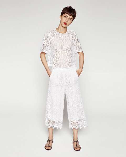 With lace shirt and flat sandals