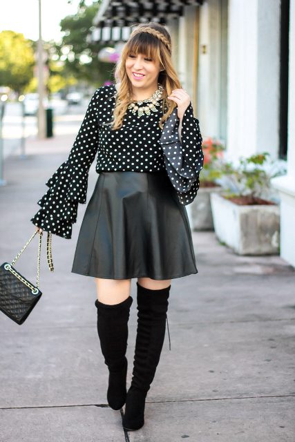 With leather skirt, over the knee boots and chain strap bag
