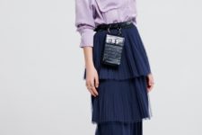 With lilac shirt, black mini bag and white sneakers