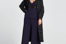 With navy blue top, checked coat and heels