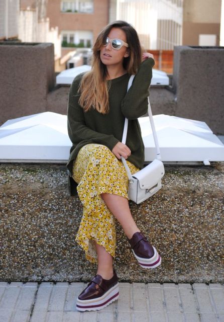 With olive green shirt, platform shoes and white bag