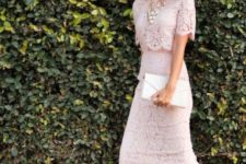 With pale pink lace skirt, clutch and beige pumps