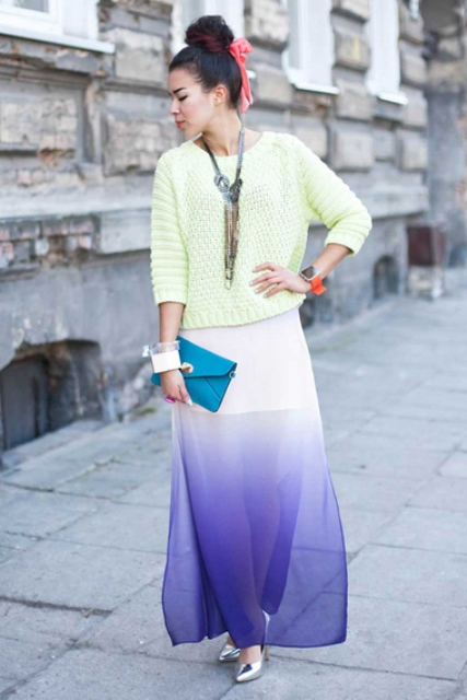 With pastel colored sweatshirt, silver pumps and small clutch