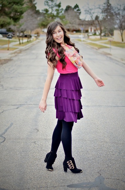 With pink shirt, floral scarf, black tights and black ankle boots
