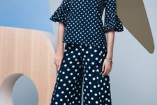 With polka dot blouse and flat shoes